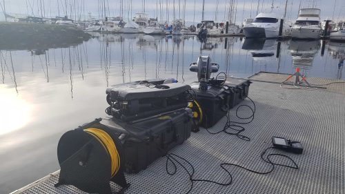 DTG3 and DT Revolution on a dock in a marina with a bunch of boats in the background